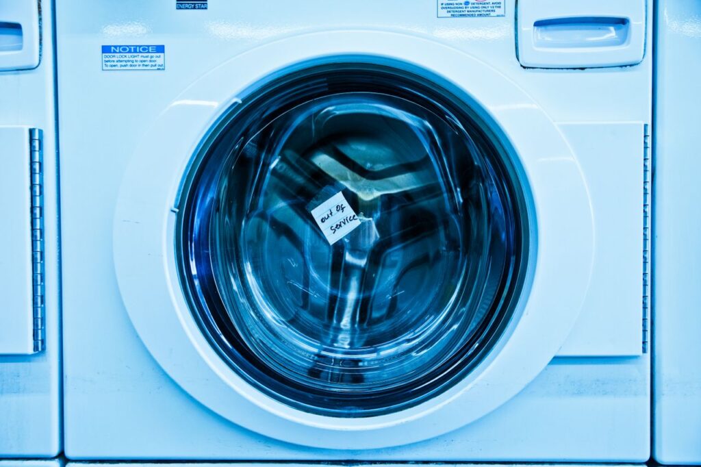 Mastering the First Impression: Your intriguing post title goes here Close-up of an out-of-service washing machine in a laundromat with a blue tint.